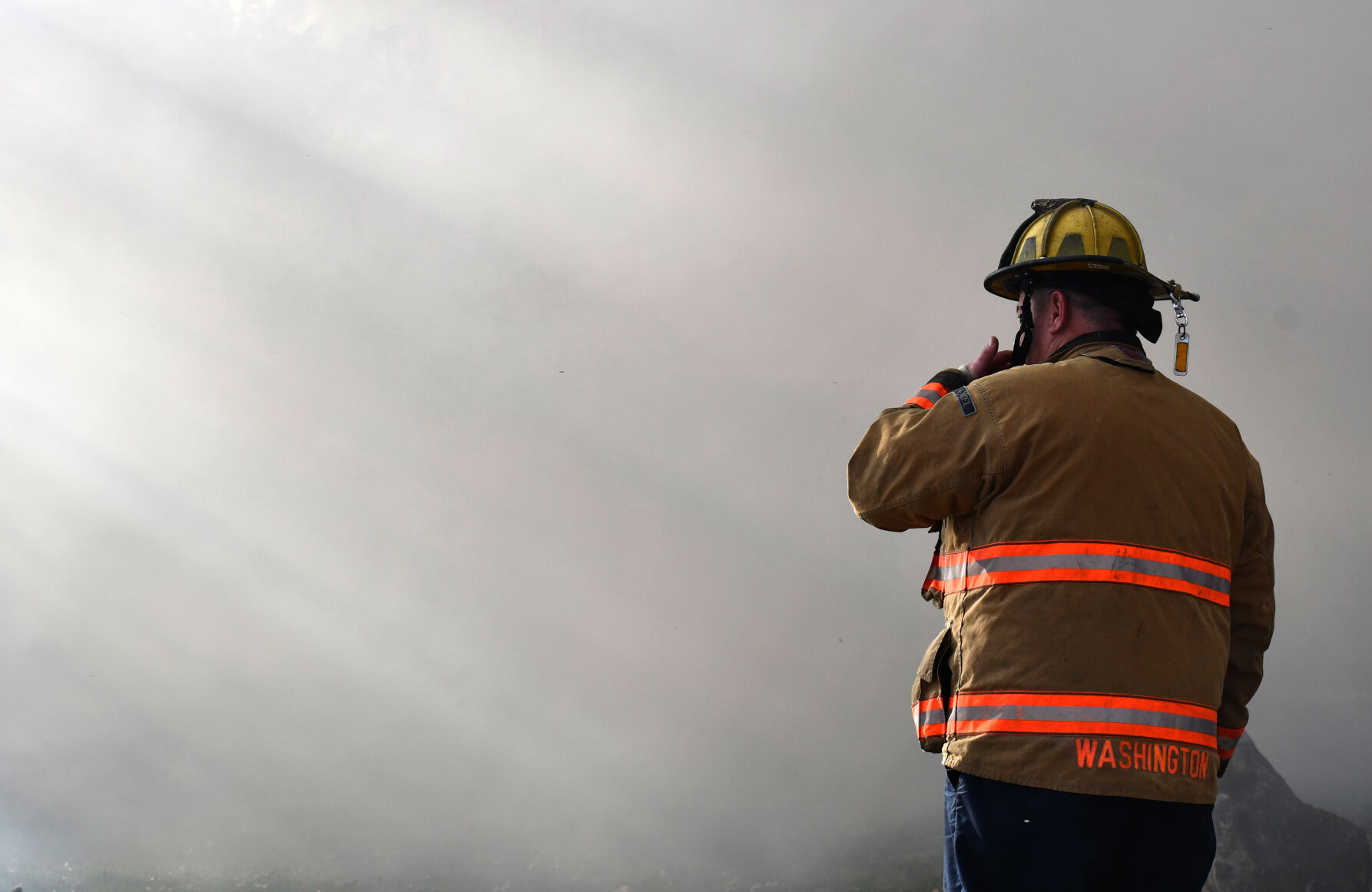 A firefighter watches the blaze